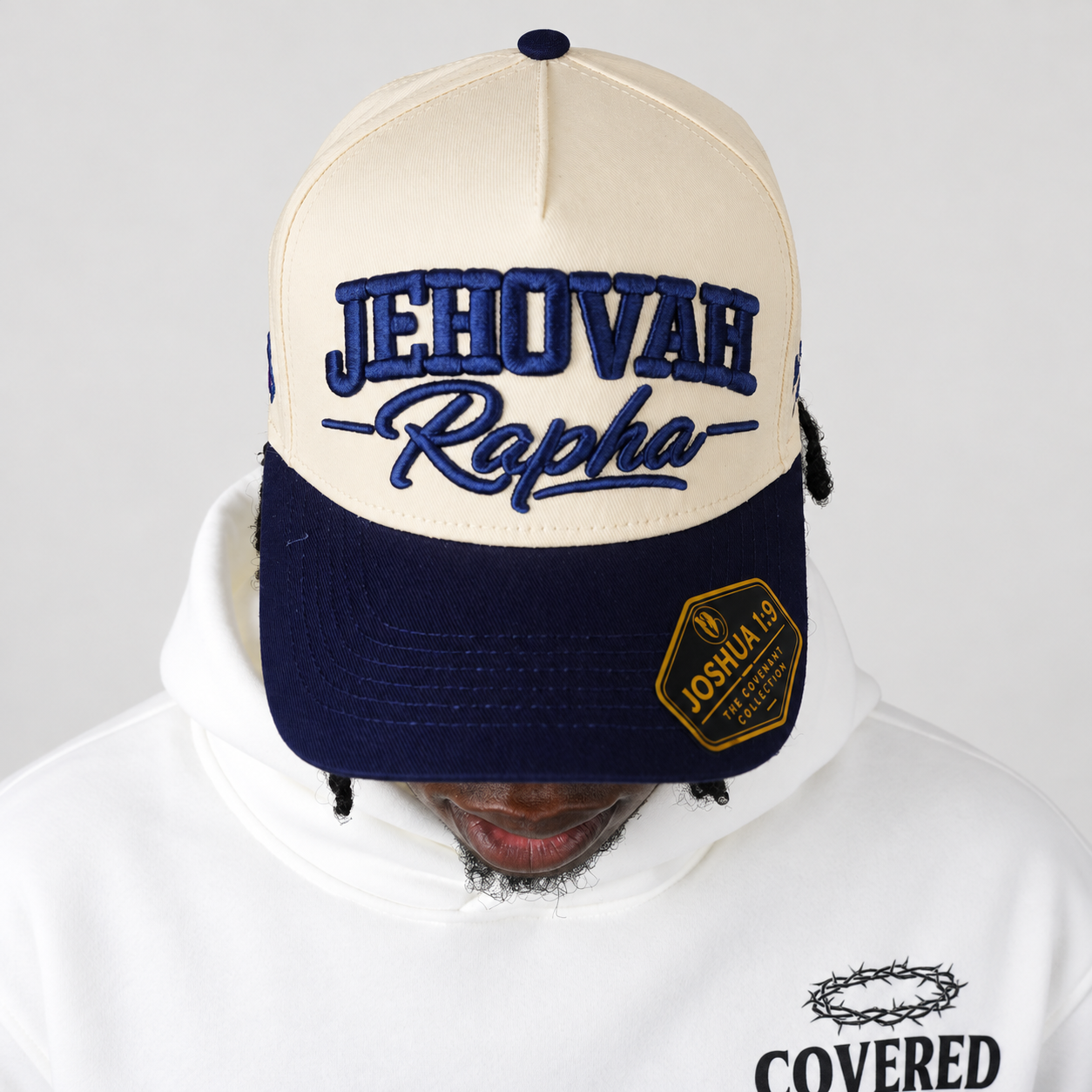 JEHOVAH RAPHA Puff Embroidered Snapback Cap | Navy Blue / Cream